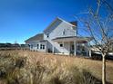 Two-story house with covered porch and backyard at 1573 Trailmore Ln, Summerville, SC 29486