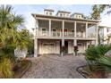 Two story home with gray siding, large front porch, and two car garage at 1860 Headquarters Plantation Dr, Johns Island, SC 29455