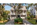 Two story home with gray siding, large front porch, and two car garage at 1860 Headquarters Plantation Dr, Johns Island, SC 29455