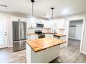 Modern kitchen with butcher block island, stainless steel appliances, and white cabinets at 200 Elliott Dr, Ladson, SC 29456