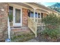 Inviting front porch with wooden railing and steps at 2065 Bishop Dr, Charleston, SC 29414