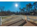 Spacious deck with white railings overlooking a wooded area at 240 Carolina Dr, Saint Stephen, SC 29479