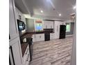 Modern kitchen with white cabinets, wood countertops, and stainless steel appliances at 2538 Cherry Point Rd, Wadmalaw Island, SC 29487