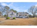 White house with landscaping and a spacious yard at 3244 Pinewood Dr, Ladson, SC 29456