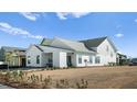 White farmhouse exterior showcasing a spacious backyard at 358 Trailmore Ln, Summerville, SC 29486