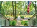 Landscaped yard with brick pathway leading to a wooded area at 376 Beresford Woods Ln, Charleston, SC 29492