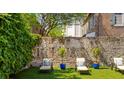 Relaxing backyard with lounge chairs and ivy covered wall at 38 Hasell St, Charleston, SC 29401