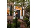 Elegant front entrance with gas lamps and brick facade at 38 Hasell St, Charleston, SC 29401