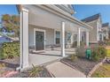 Inviting front porch with white columns and stone accents at 459 Spring Hollow Dr, Charleston, SC 29492