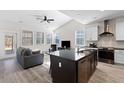 Open kitchen with granite island, stainless steel appliances, and hardwood floors at 5100 Park Creek Ave, North Charleston, SC 29418