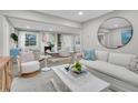 Bright living room with comfy seating, fireplace, and large mirror at 561 Saint Andrews Blvd, Charleston, SC 29407