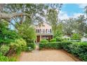 Two-story house with landscaped front yard and gravel driveway at 14 1/2 Murray Blvd, Charleston, SC 29401