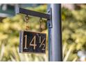 Black metal house number sign with gold lettering reading 14 1/2 at 14 1/2 Murray Blvd, Charleston, SC 29401