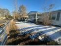 Snow covered yard with wooden fence and home partially visible at 141 Nottingham Ln, Yemassee, SC 29945