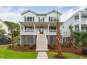 Two-story white home with dark shutters, front porch, and raised foundation at 1647 Siloh Dr # 486, Mount Pleasant, SC 29466