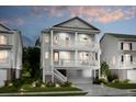 Two-story light gray house with a front porch and attached garage at dusk at 1655 Siloh St # 488, Mount Pleasant, SC 29466