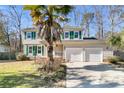 Two-story house with green shutters, palm tree, and a two-car garage at 174 Winding Rock Rd, Goose Creek, SC 29445