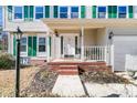 Inviting front porch with seating area and brick steps at 174 Winding Rock Rd, Goose Creek, SC 29445