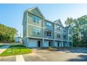Townhome building with attached garages, green and gray siding at 202 Cache Ct # 2, Charleston, SC 29414