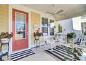 Relaxing front porch with white rocking chairs and a cheerful atmosphere at 203 Oak View Way, Summerville, SC 29483