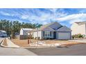 Gray siding house with a two-car garage and small front yard at 221 Rubles Ln, Moncks Corner, SC 29461