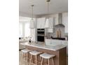 Modern kitchen with island, white cabinets, and marble countertops at 323 Abercom Place Dr, Moncks Corner, SC 29461