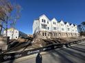 Row of three-story townhomes, white siding, brick accents at 5134 Double Eagle, Summerville, SC 29485