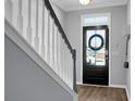 Modern entryway featuring a black front door and wood-toned floors at 563 Alderly Dr, Moncks Corner, SC 29461