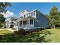 Two-story house with gray siding, a metal roof, and a side yard at 748 Maynard Ln, Summerville, SC 29486