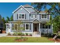 Two-story house with gray siding, a metal roof, and a front porch at 748 Maynard Ln, Summerville, SC 29486