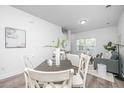 Dining area with farmhouse-style table and chairs, adjacent to living room at 101 Aplomb Alley # 10, Charleston, SC 29414