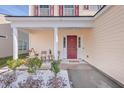 Covered front porch with seating area and red front door at 111 Brittondale Rd, Summerville, SC 29485