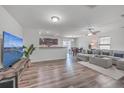 Open living room with L-shaped sectional sofa and hardwood floors at 111 Brittondale Rd, Summerville, SC 29485
