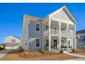 Charming two-story home with a front porch and landscaped yard at 128 Sandy Bend Ln, Summerville, SC 29486