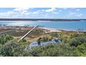 Aerial view showcasing home's location on waterfront property with private dock at 153 Dewees Inlet Dr, Dewees Island, SC 29451