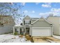 Two-story house with light green siding, white garage door, and a porch at 2005 Isabela Ct, Summerville, SC 29483