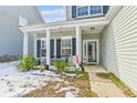 Covered front porch with white columns and a black bench at 2005 Isabela Ct, Summerville, SC 29483