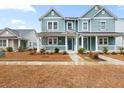 Two-story house with light teal siding, white trim, and a porch at 312 Parish Farms Dr, Summerville, SC 29486