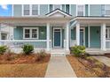 Front porch with white columns, a swing, and landscaping at 312 Parish Farms Dr, Summerville, SC 29486