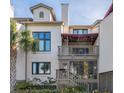 Charming two-story home with balcony and landscaped grounds at 407 Yacht Harbor Ct, Isle of Palms, SC 29451