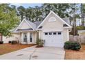 House exterior showcasing a white garage and neatly kept lawn at 4845 Carnoustie Ct, Summerville, SC 29485