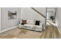 Living area with a beige sofa, a glass coffee table, and a neutral color scheme at 538 Harris Hill Rd, Johns Island, SC 29455