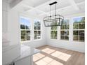 Spacious dining area with hardwood floors and a large chandelier at 6522 Beagle Club Rd, Meggett, SC 29449