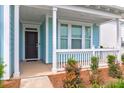 Inviting front porch with white railing and dark door at 105 Waxwing Dr, Summerville, SC 29483