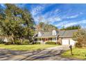 Ranch style brick home with a red door and attached two-car garage at 1219 Edward Dr, Moncks Corner, SC 29461