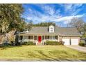 Ranch style brick home with a red door and attached two-car garage at 1219 Edward Dr, Moncks Corner, SC 29461