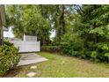 Small backyard with a patio, white fence, and lush greenery at 1762 Bee Balm Rd, Johns Island, SC 29455