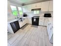 Modern kitchen with stainless steel appliances and white cabinets at 209 Palmetto Blvd, Edisto Beach, SC 29438