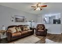 Living room with brown leather couch and chair, and access to sunroom at 2345 Tall Sail Dr # C, Charleston, SC 29414