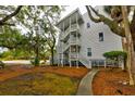 Exterior view of building with outdoor staircase leading to upper level at 251 Driftwood Ln # 251, Edisto Island, SC 29438